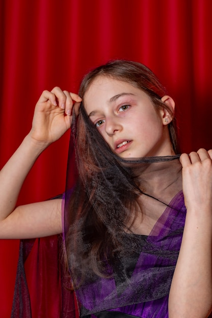 Portrait of a teenage girl in purple with a black dress. Art, model posing.