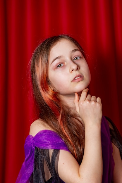 Portrait of a teenage girl in purple with a black dress. Art, model posing.