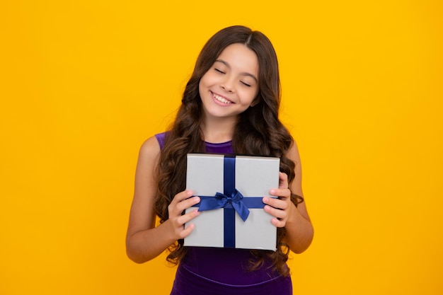 Portrait of teenager child girl 12 13 14 years old holding Christmas gift box Teen giving birthday gift