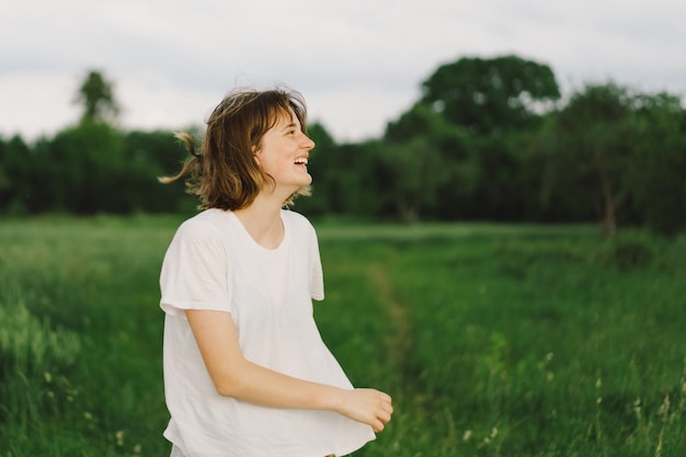 Portrait Of Teenager Girl Happy Cheerful Teen Girl With Pronounced Face dancing In Outdoors