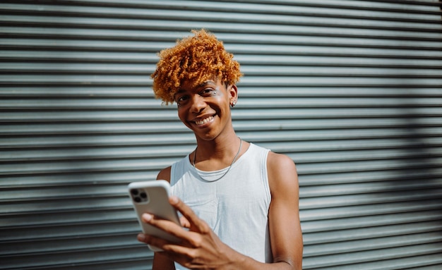 Portrait of the teenager multiracial man smiling confident while making selfie by the camera at the