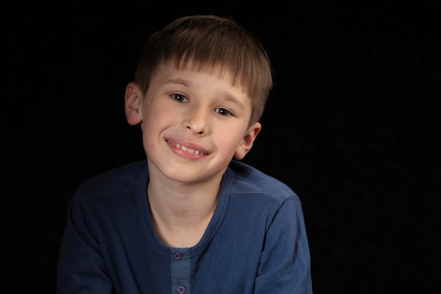 Portrait of a tenyearold boy on a dark background