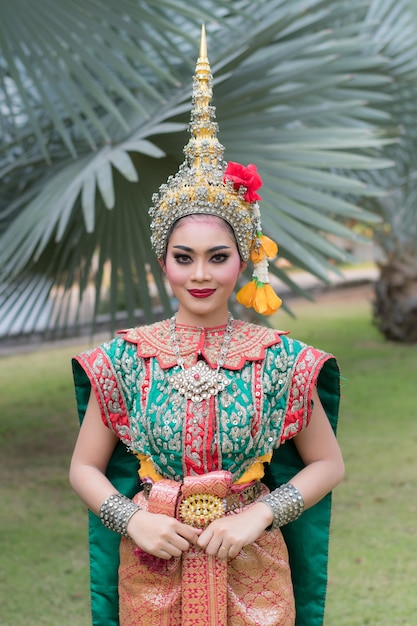 Portrait of Thai young lady wearing Thai traditional dress in the garden