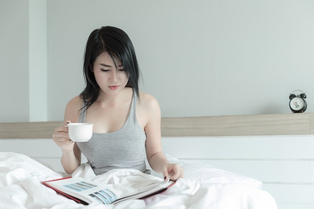 portrait thailand woman drinking relaxation in the bedroom in holliday