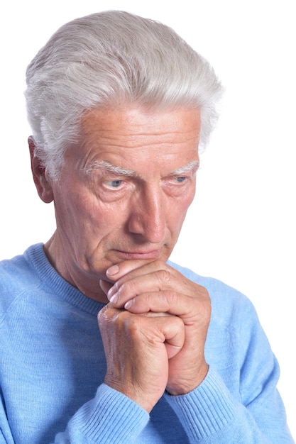 Portrait of thoughtful senior man posing isolated