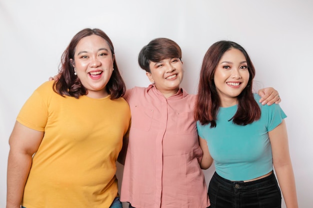 A portrait of three friends are smiling expressing happy feeling isolated by white background