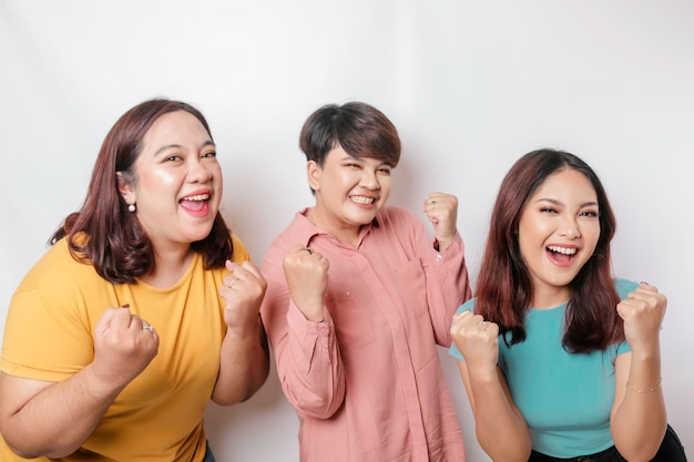 A portrait of three friends with a happy successful expression isolated by a white background