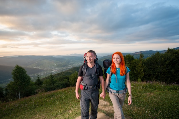 Portrait of tourists man and woman with backpacks