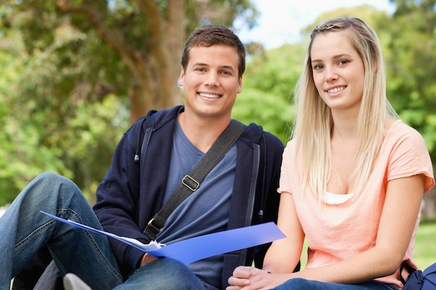 Portrait of a tutor helping a teenager to revise 