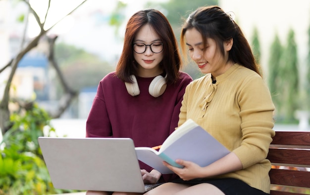 Portrait of two beautiful Asian female college students at school