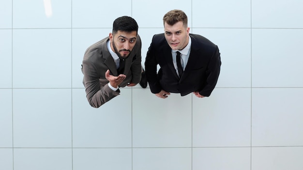 Portrait of two concentrated businessmen partners dressed in formal suit