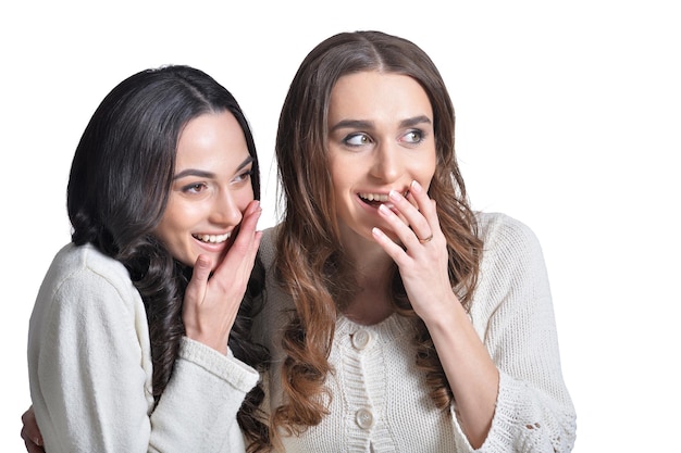 Portrait of two female friends against white background