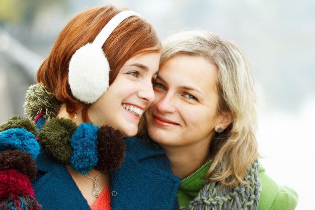 Portrait of two girls who are having pretty much fun in the park They are talking discussing laughing at each other and have a really good time