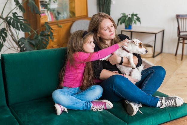 Portrait of two people lovely mom and her kid hug they are spend free time together sit comfy divan