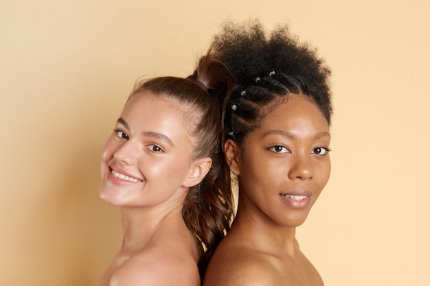 Portrait of two young multiracial women with perfect moisturizing skin standing fpchallengediversity