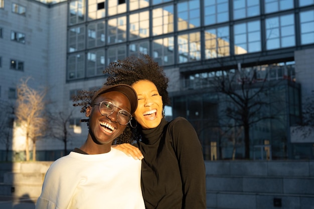 Portrait two young women of generation z happiness and laughter as the wind moves into a sunny and windy day