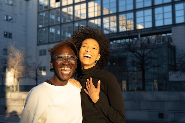 Portrait two young women of generation z two young African American women smiling friends laughing lgbt couple diversity concept copy space