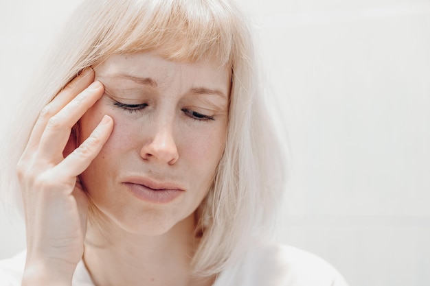 Portrait of an unhappy woman on a white background