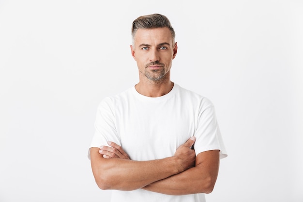 Portrait of unshaved man 30s with bristle wearing casual t-shirt posing isolated on white