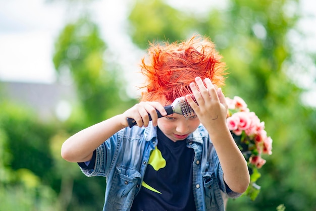 Portrait of an unusual boy 9 years old with bright red hair