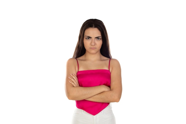 Portrait of an upset unsatisfied brunette girl standing and looking at camera