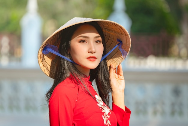 Portrait of Vietnamese girl traditional red dress,Beautiful young asian woman wearing Vietnam