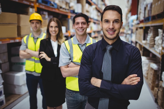 Portrait of warehouse manager and workers in warehouse