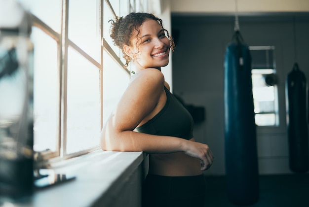 Portrait window and woman with smile fitness and workout for wellness healthy lifestyle or exercise Happy female lady or athlete in gym training sunshine or practice for cardio energy or power