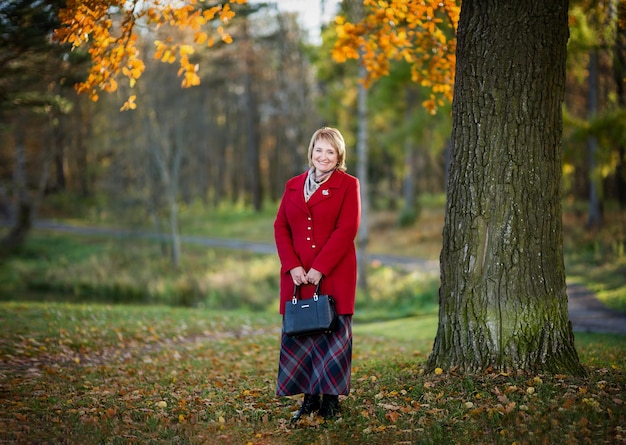 Portrait of a woman against the background of autumn nature