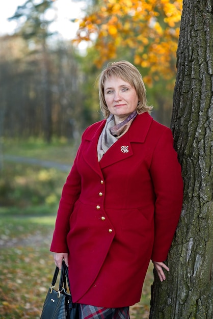 Portrait of a woman against the background of autumn nature