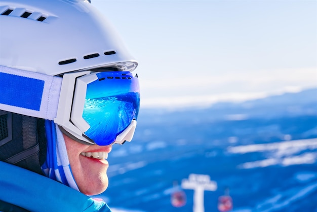 Portrait of woman in alps woman in ski goggles at the ski resort reflection in ski goggles