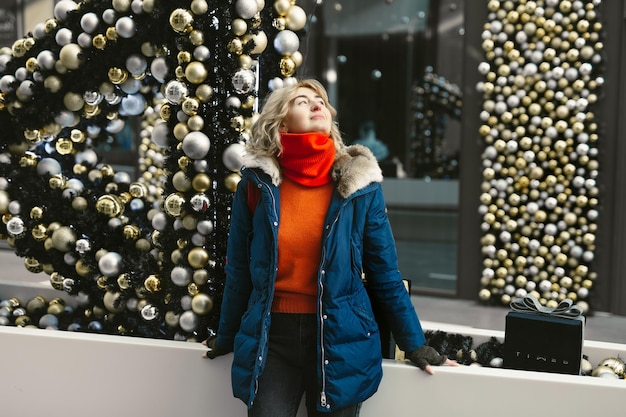 Portrait of a woman on the background of decorations made of bright Christmas balls