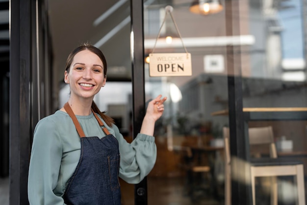 Portrait of woman barista cafe owner Small business entrepreneur with open sign