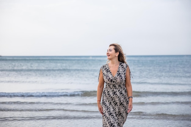 Portrait of a woman on the beach ocean unity with nature healthy lifestyle