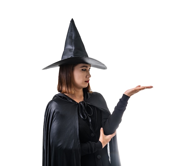 Portrait of woman in black Scary witch halloween costume standing with hat isolated white 