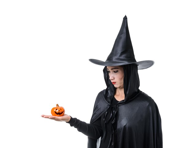 Portrait of woman in black Scary witch halloween costume standing with hat isolated