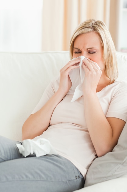 Portrait of a woman blowing her nose