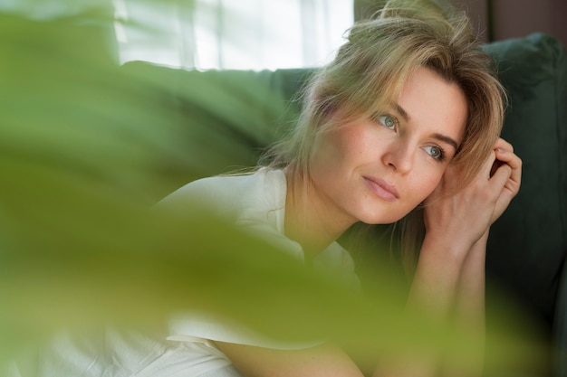 Portrait of a woman and blurred plant