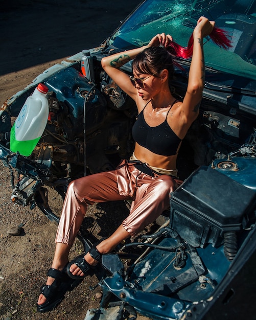 portrait of a woman in a broken car