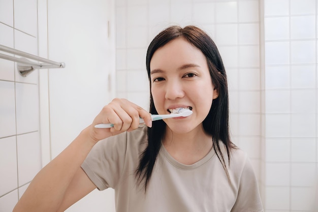 Portrait of woman brushing teeth