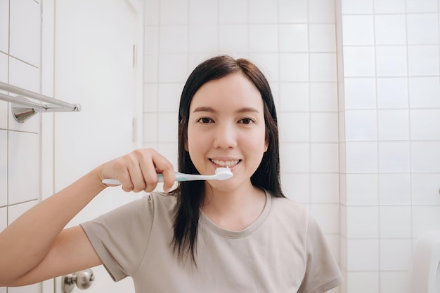 Portrait of woman brushing teeth