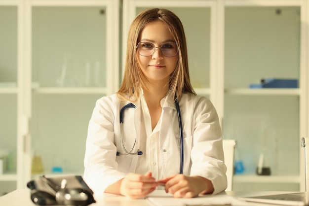 Portrait of woman doctor in white medical coat in clinic health insurance concept