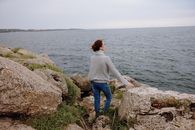 Portrait of a woman freedom walk on the stone coast female relaxing