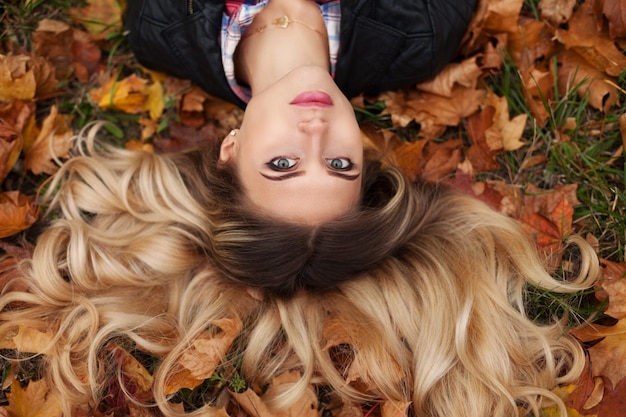 Portrait of woman on golden autumn nature background