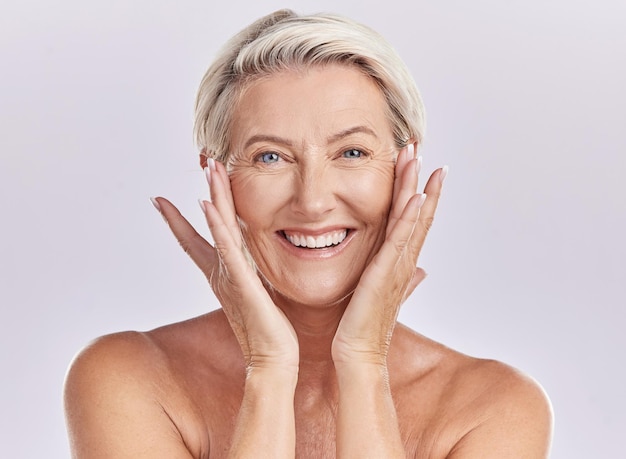 Portrait of a woman happy face smile with healthy skincare while posing in a studio against purple mockup studio background Elderly woman doing her wellness skin cosmetic treatment routine