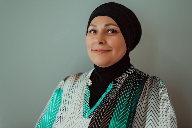 Portrait of a woman in a hijab with crossed arms isolated on a gray background