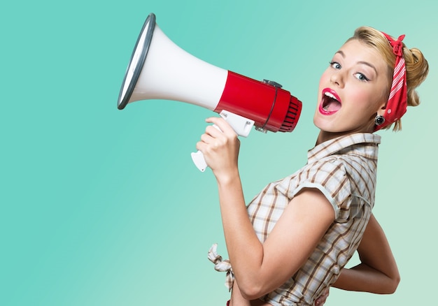 Portrait of woman holding megaphone, dressed in pin-up style