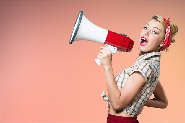 Portrait of woman holding megaphone, dressed in