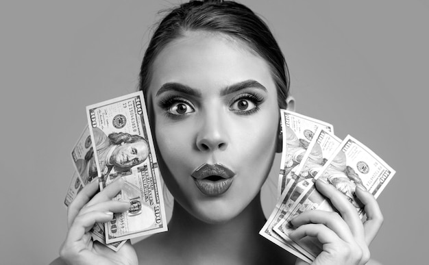 Portrait woman holding money banknotes Girl holding cash money in dollar banknotes Woman holding lots of money in dollar currency Luxury beauty and money concept