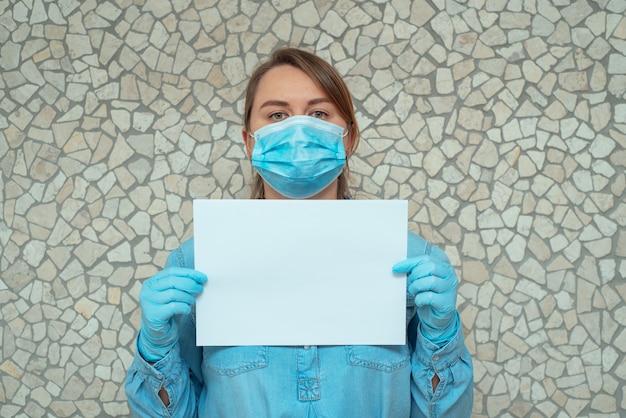 Portrait of a woman holding a white sheet of paper